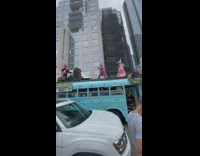 Band performs on top of blue school bus