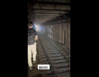 Collab WINY - People walk on ledge of subway tunnel