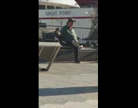 Man sit on bench feed some pigeons