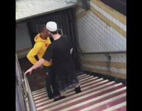 Two guys fight on stair way 