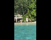 Guy takes picture of girl kicks water at her