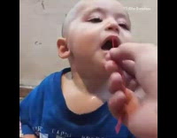 Dad tickles baby boy with rubber band 