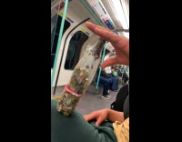 Man holds organic bee collection inside train