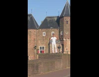 Man in white outfit sings in front of the aerial drone