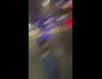 Woman kneels and sways her hair near the water fountain
