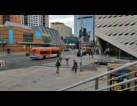 Girl wearing pink dress on sidewalk 