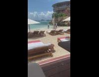 Woman white polo walk towards camera beach