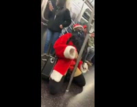 Woman in Santa Claus suit screams on the floor on subway train