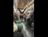 Man swings and dances inside the subway train 