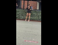 Lady in Black Dress Poses on Street 