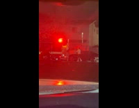 Collab IITW - Woman poses behind firetruck on the street