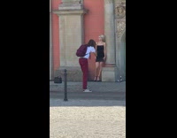 Woman in black dress leans on the column