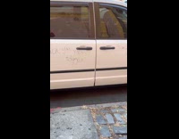 Flat car with vandalized message on body