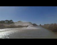 Silver car pulls guy on boogie board 