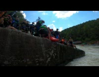 People lift and throw guy in kayak into water