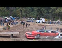 Stunt driver crash stack of demolition cars