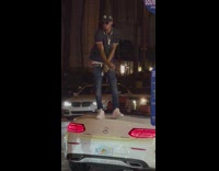 Guy stand on convertible car hold cash