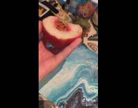 Girl bites spicy seed fruit 