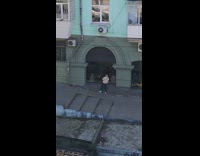 girl outside blue building window 