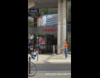 Woman in orange sweater poses in front of the restaurant