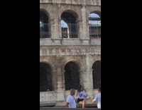 Girl white nike shirt sit ledge colosseum