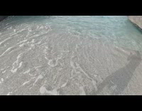 Action Camera on a hand grip thrown to the beach ocean
