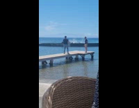 Man black shirt stand on platform beach