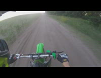 Guy ride dirt bike drive through plants