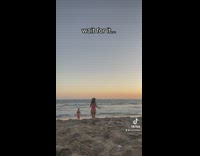 Two friends run into ocean seagull walks in front of camera 