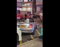 Small white dog poses on convertible car