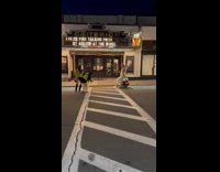 Woman poses beside Moped cheered by filmer