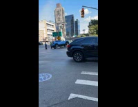 Blue car stuck over barricade on road