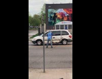 Two guys fight in middle of road