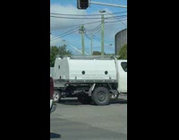 Two men juggle pins at the stoplight