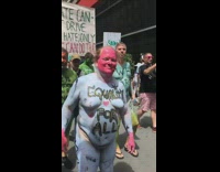 Environmentalist group protests by marching down the street naked with bodies painted