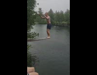 Guy double backflip wood plank lake rain
