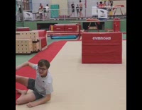 Boy backflips off red block and lands on head inside gym