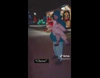 Baby held up by guy says cheese 