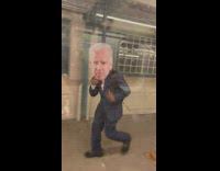 Man in suit with biden face cutout