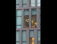 Guy wears transformer costume near window