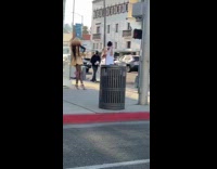 Woman yellow dress sidewalk trash photo shoot