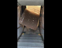 Girl carries large black poster board subway 