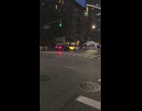 People ride ATV motorcycle wheelie street night