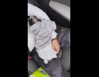 Girl with sleeping baby goat on lap 