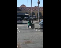Woman green coat spread legs parking lot