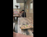 Guy uses camera to photograph food outside 