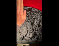 Pin art face emerge from other side