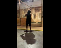 Man on longboard throws axe and catches the hat