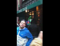 Drunk guys wait outside full crowded bar