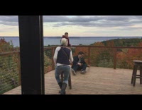 Two guys picture on deck overlooking lake